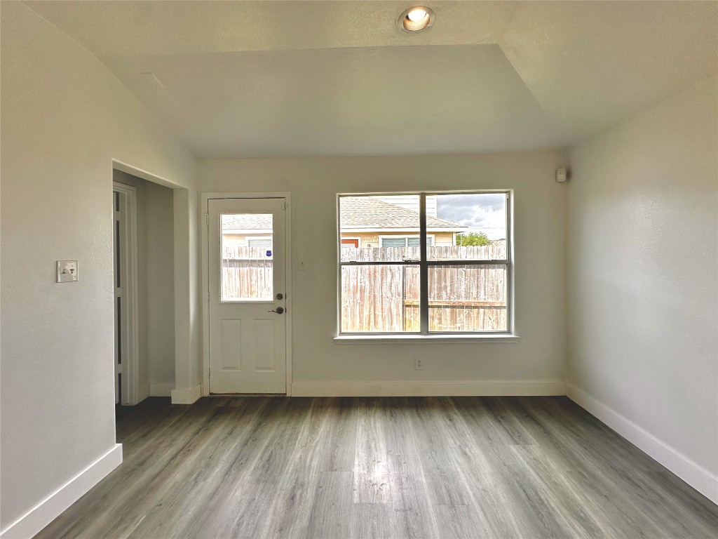8202 Radial Court Rosharon, TX 77583 - Photo 15 of 27 an empty room with wooden floor and windows