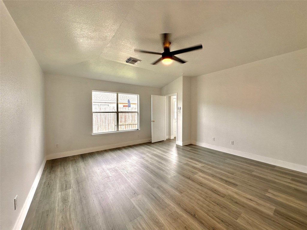8202 Radial Court Rosharon, TX 77583 - Photo 17 of 27 an empty room with wooden floor fan and windows