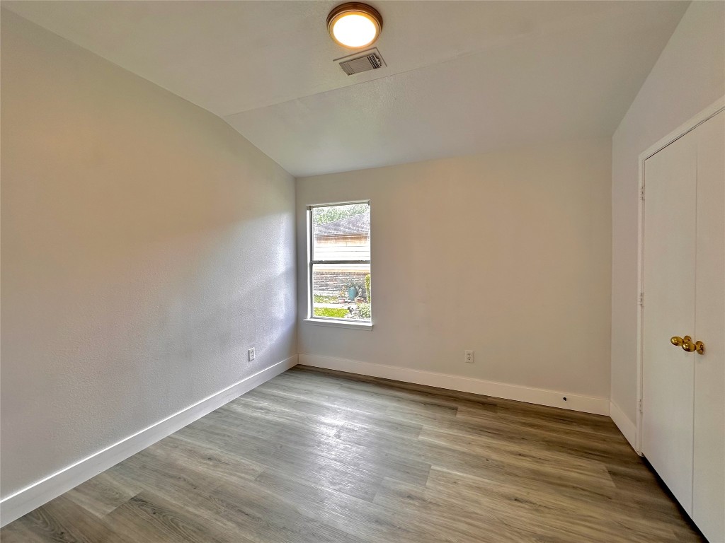 8202 Radial Court Rosharon, TX 77583 - Photo 19 of 27 wooden floor in an empty room with a window