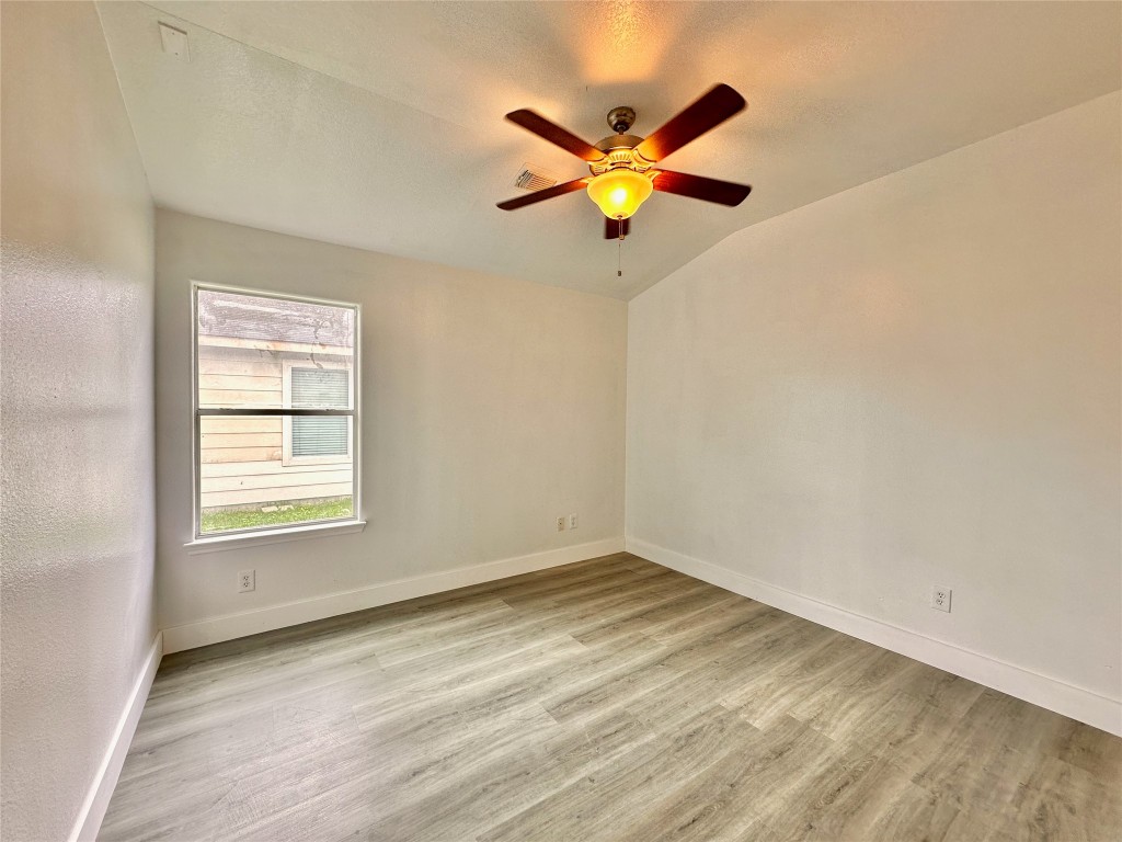 8202 Radial Court Rosharon, TX 77583 - Photo 21 of 27 an empty room with window and wooden floor