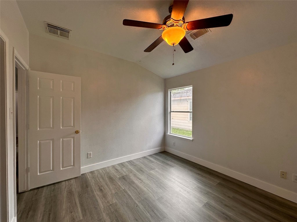 8202 Radial Court Rosharon, TX 77583 - Photo 22 of 27 an empty room with wooden floor fan and windows