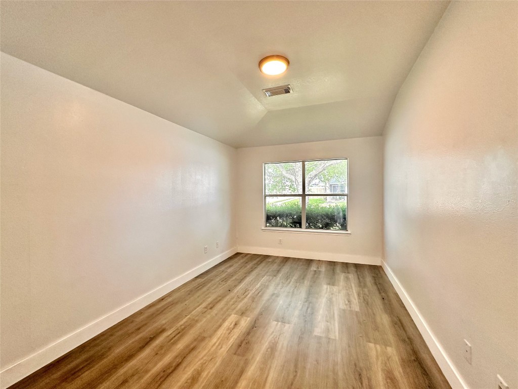 8202 Radial Court Rosharon, TX 77583 - Photo 23 of 27 wooden floor in an empty room with a window