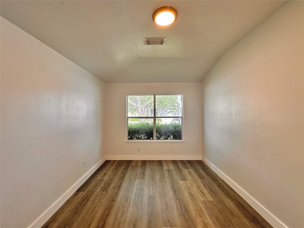 8202 Radial Court Rosharon, TX 77583 - Photo 24 of 27 an empty room with wooden floor and windows