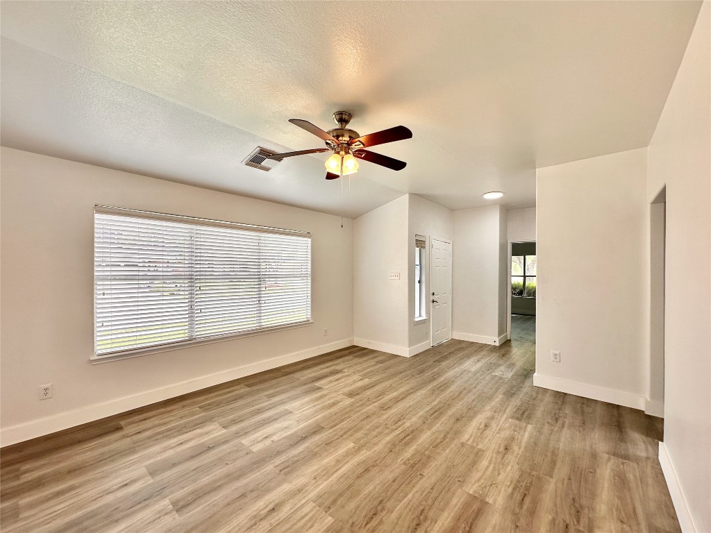 8202 Radial Court Rosharon, TX 77583 - Photo 4 of 27 wooden floor in an empty room with a window