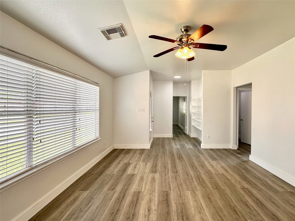 8202 Radial Court Rosharon, TX 77583 - Photo 7 of 27 a view of empty room with wooden floor and fan