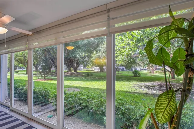 a view of a room with green trees in front of it