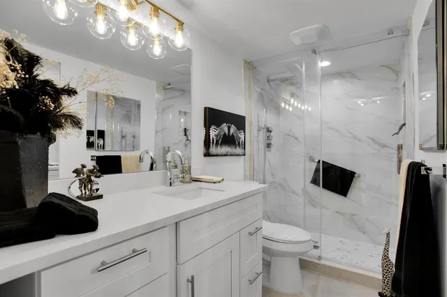 a bathroom with a sink a large mirror and vanity