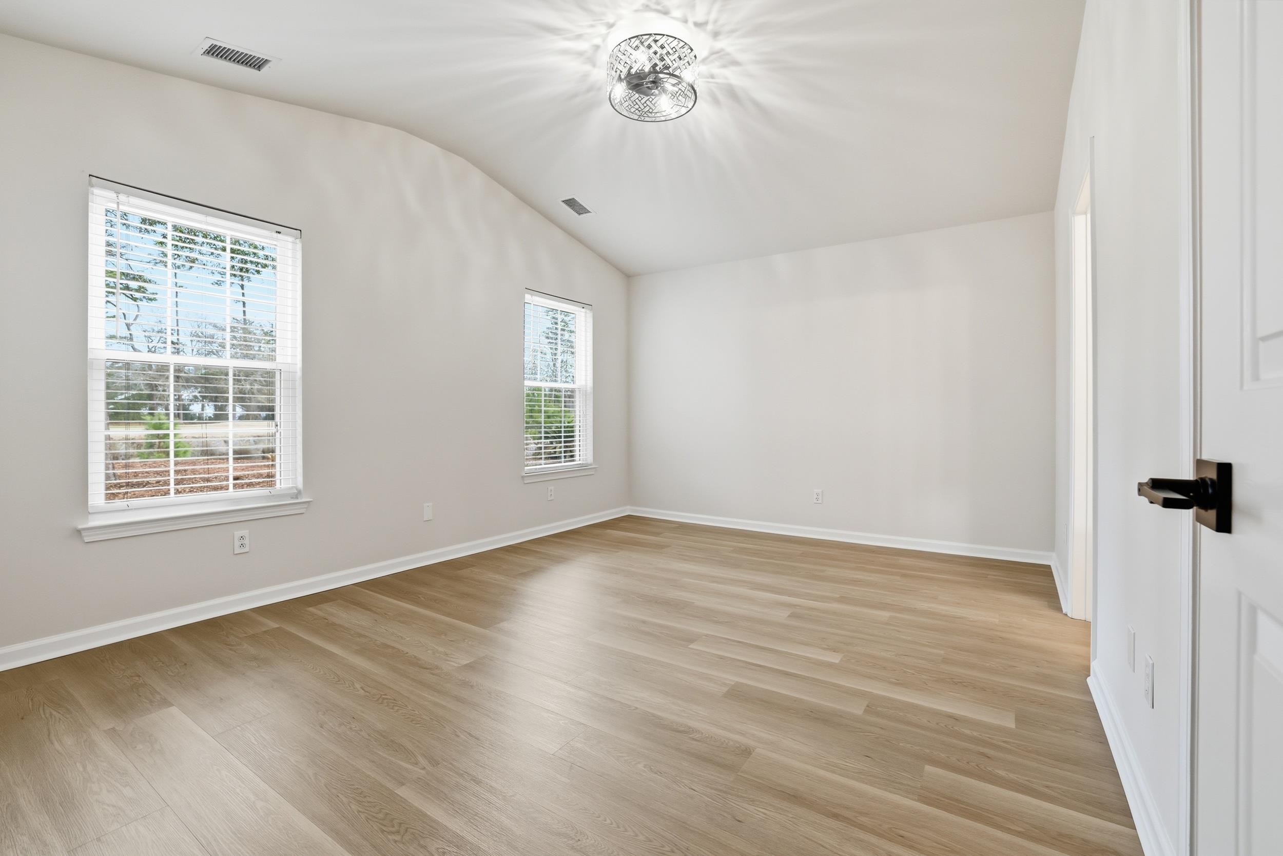 4566 Fringetree Drive Murrells Inlet, SC 29576 - Photo 11 of 36 Unfurnished room with vaulted ceiling and light wood-style flooring