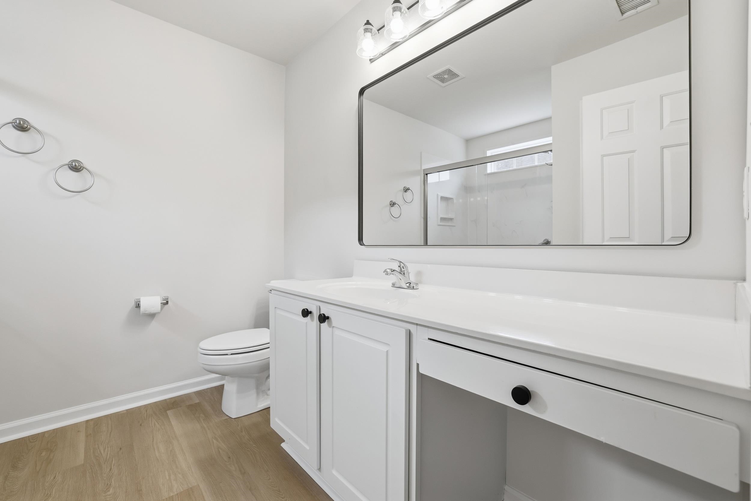 4566 Fringetree Drive Murrells Inlet, SC 29576 - Photo 13 of 36 Full bath with a stall shower, vanity, and light wood-style floors