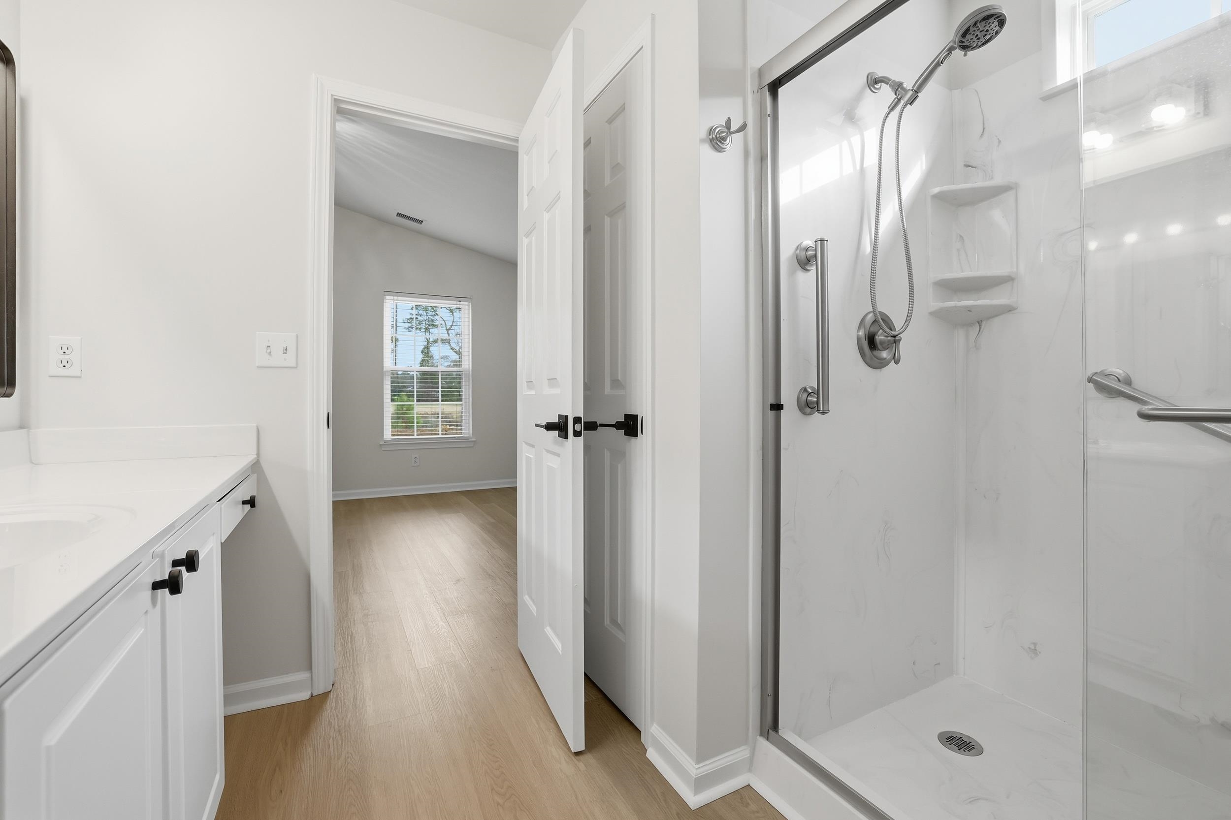 4566 Fringetree Drive Murrells Inlet, SC 29576 - Photo 14 of 36 Full bath with lofted ceiling, a marble finish shower, vanity, and light wood finished floors