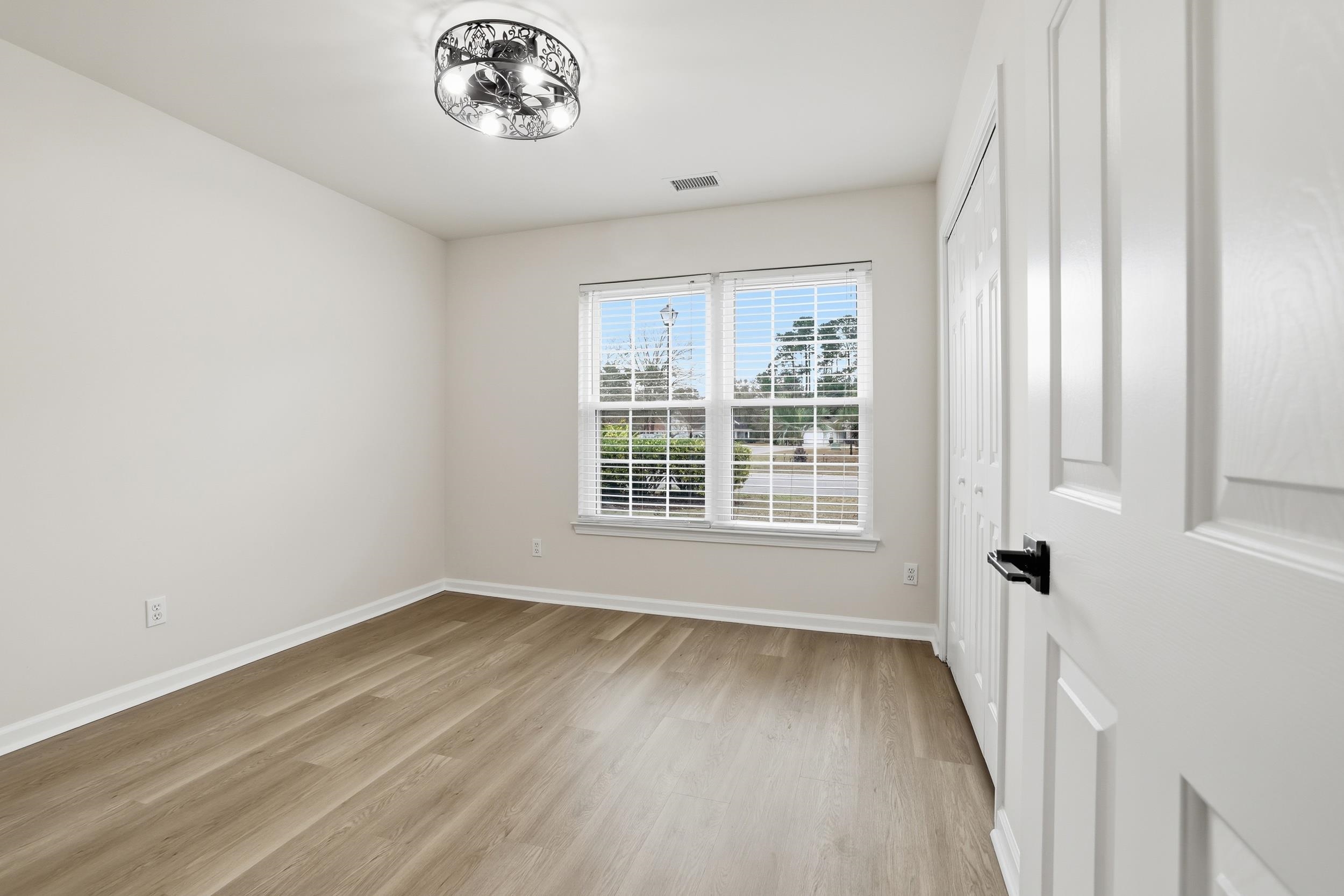 4566 Fringetree Drive Murrells Inlet, SC 29576 - Photo 15 of 36 Empty room featuring light wood-type flooring and baseboards