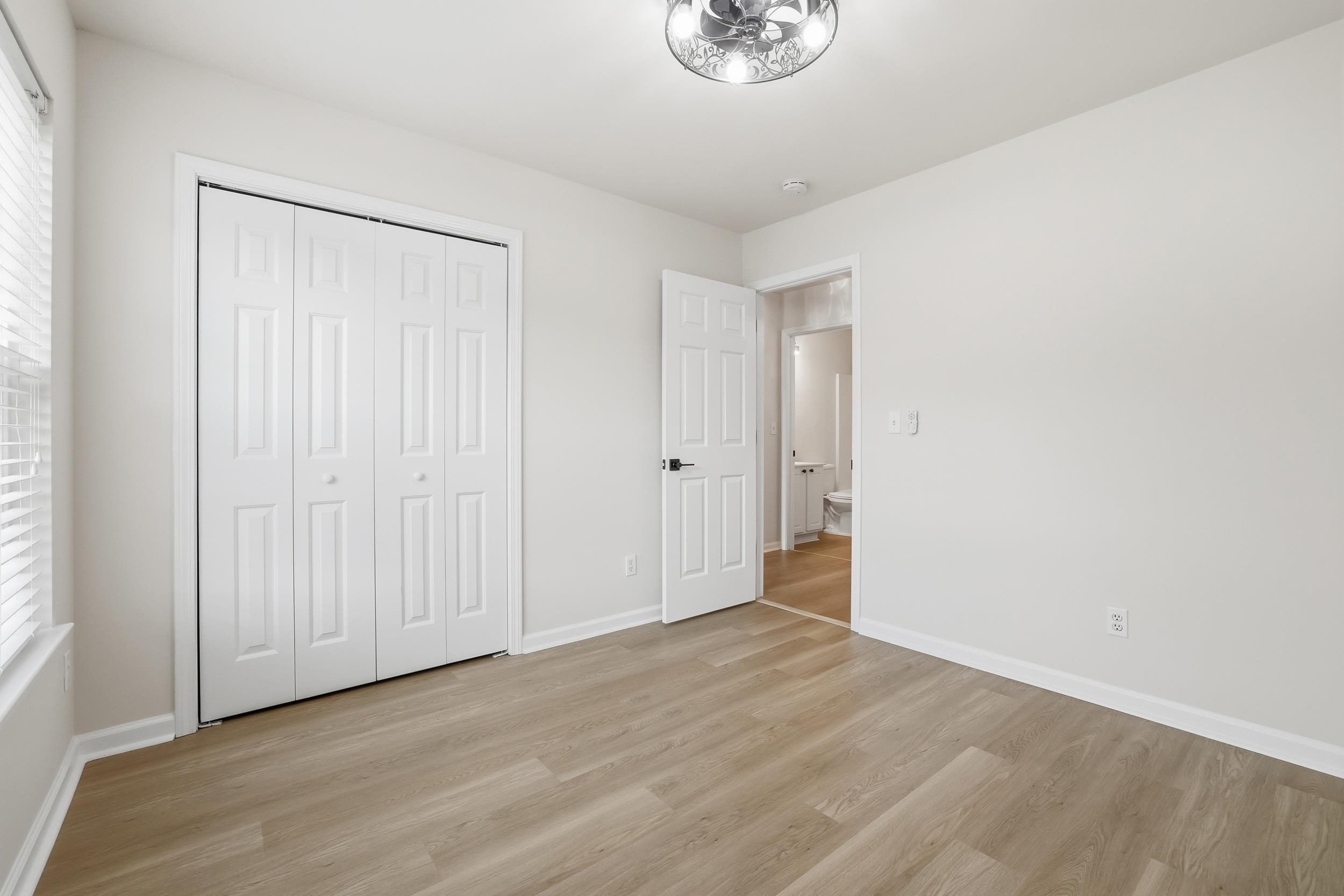 4566 Fringetree Drive Murrells Inlet, SC 29576 - Photo 16 of 36 Unfurnished bedroom featuring light wood-style flooring and a closet