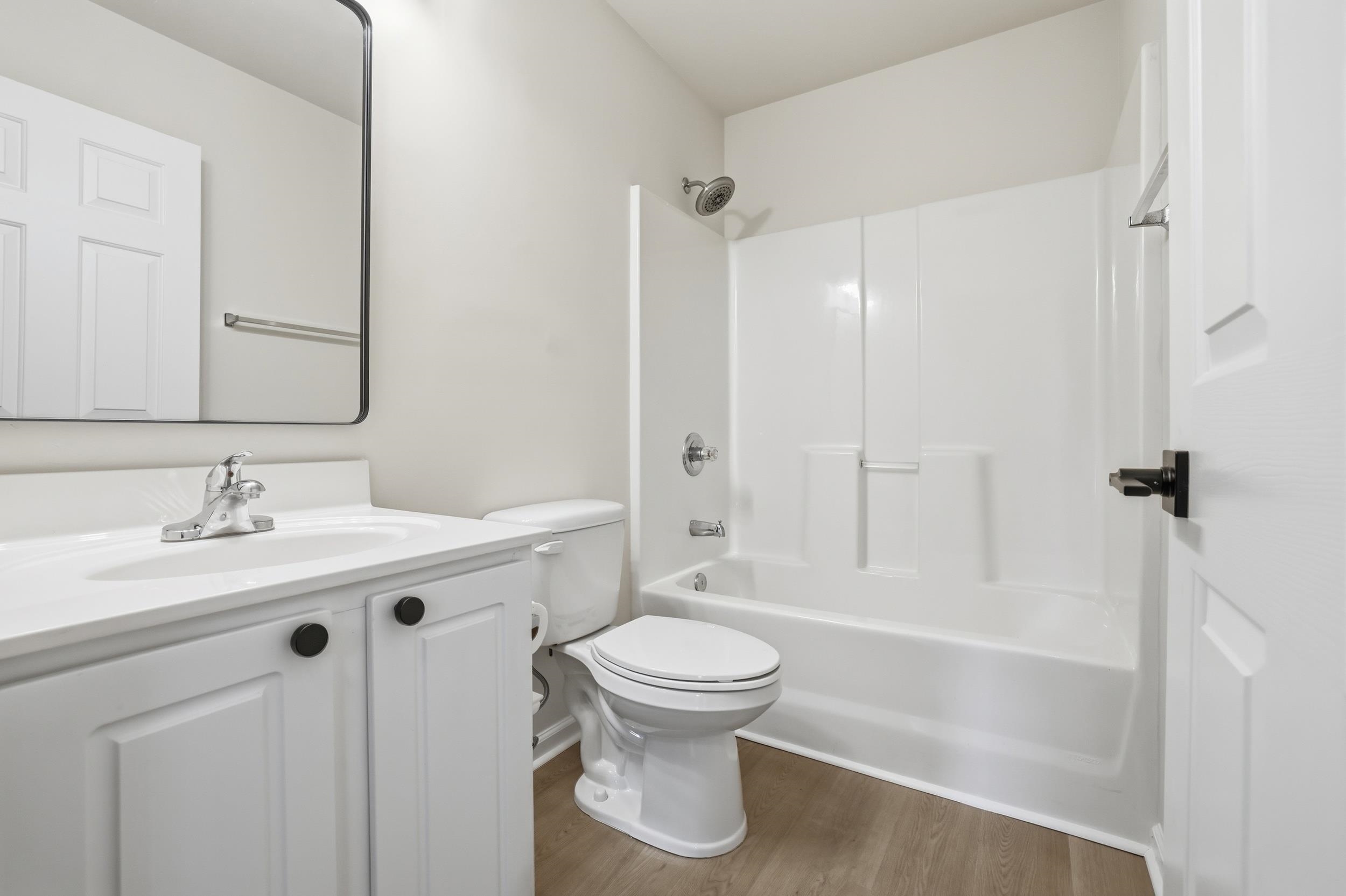 4566 Fringetree Drive Murrells Inlet, SC 29576 - Photo 17 of 36 Full bath with bathing tub / shower combination, vanity, and light wood finished floors