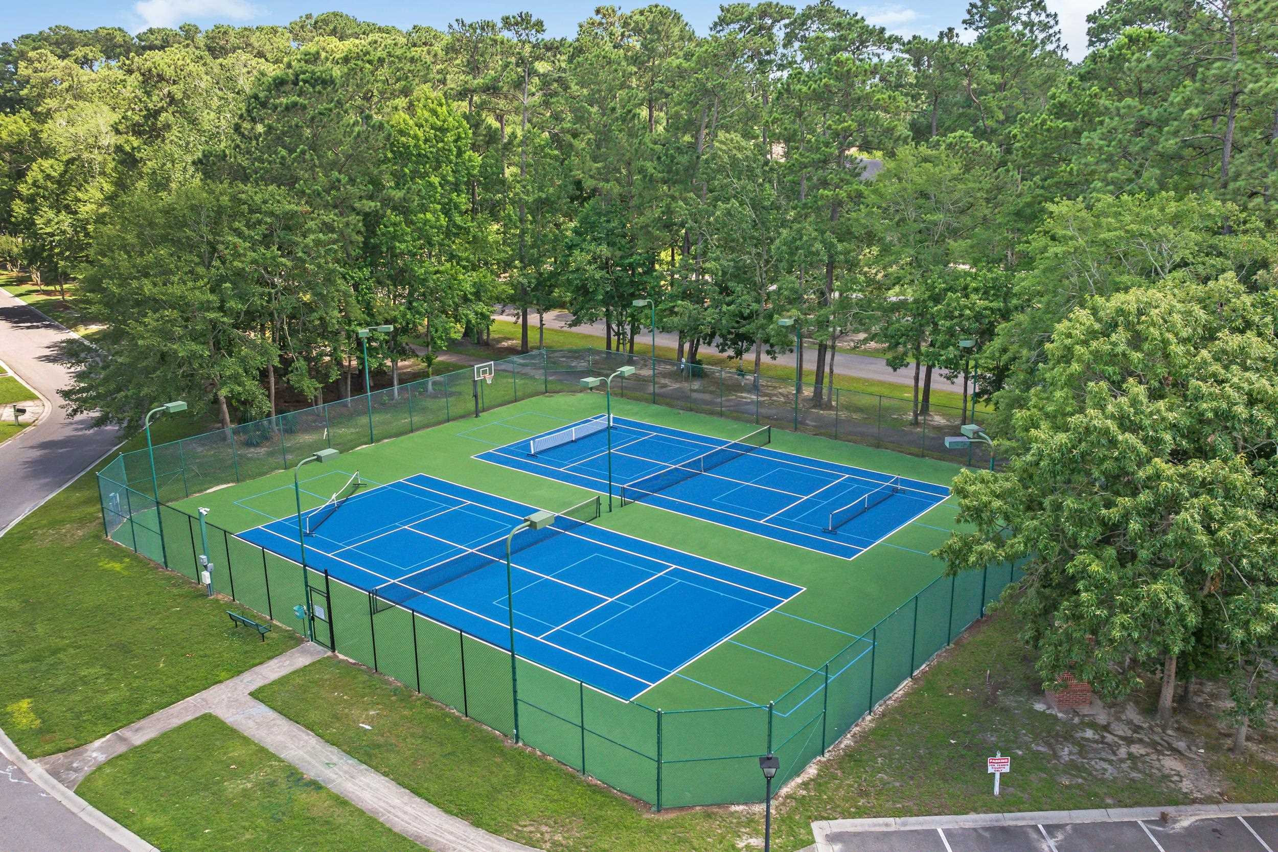4566 Fringetree Drive Murrells Inlet, SC 29576 - Photo 34 of 36 View of tennis court featuring community basketball court and view of scattered trees