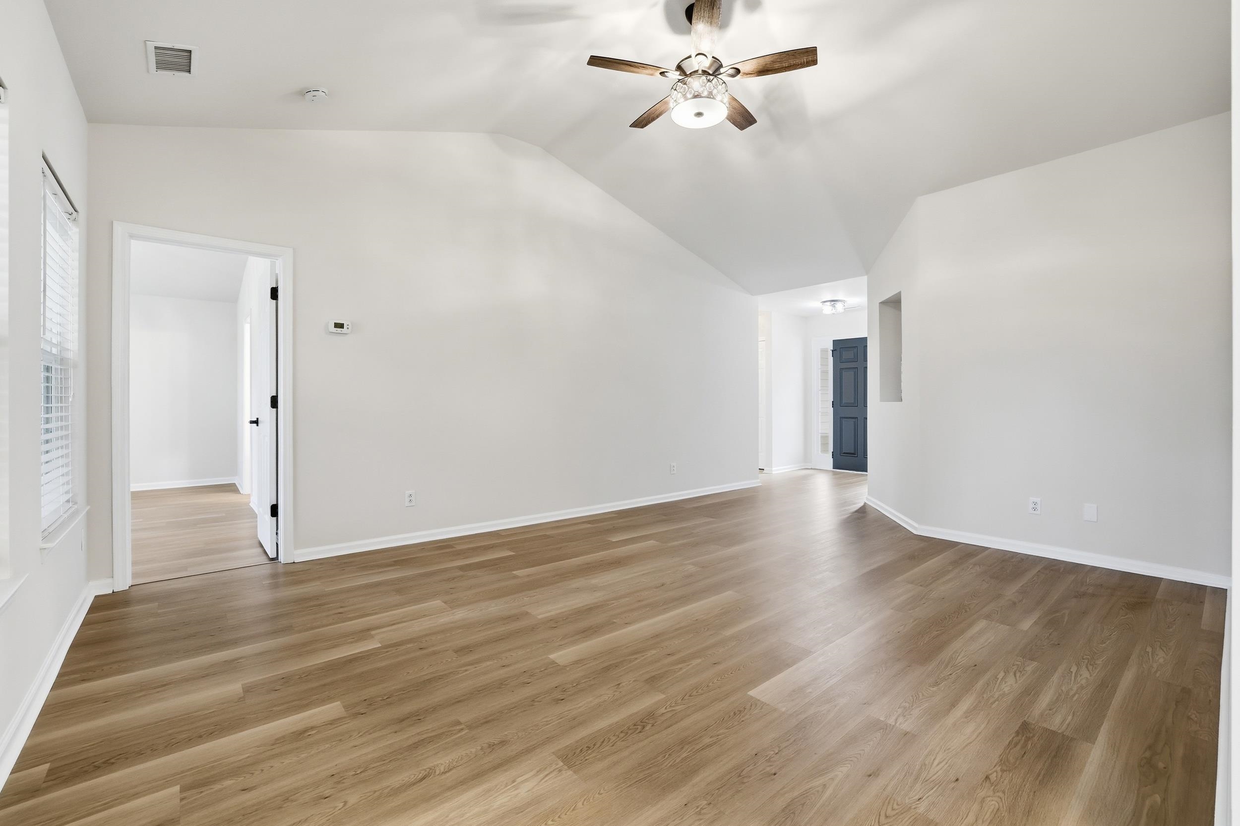 4566 Fringetree Drive Murrells Inlet, SC 29576 - Photo 8 of 36 Spare room with light wood-style floors, vaulted ceiling, and ceiling fan