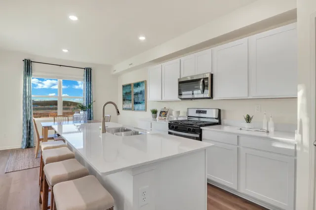 a kitchen with a sink a stove and cabinets