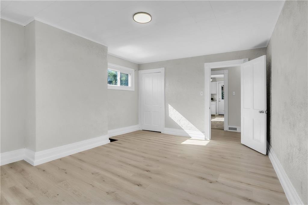 1229 McKee Road Crescent, PA 15046 - Photo 14 of 32 an empty room with wooden floor and white walls