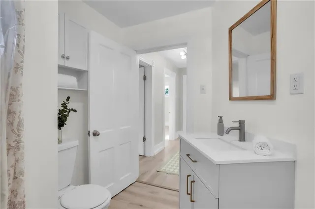 a bathroom with a sink toilet and shower