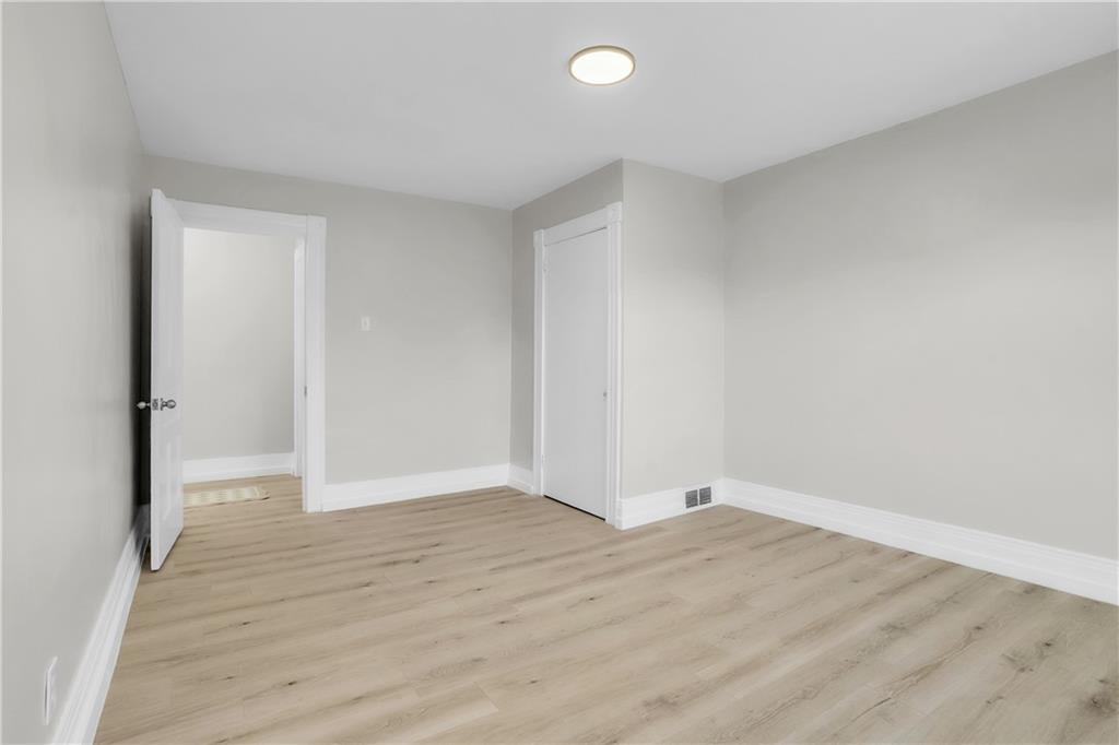 1229 McKee Road Crescent, PA 15046 - Photo 20 of 32 a view of an empty room with wooden floor and a window