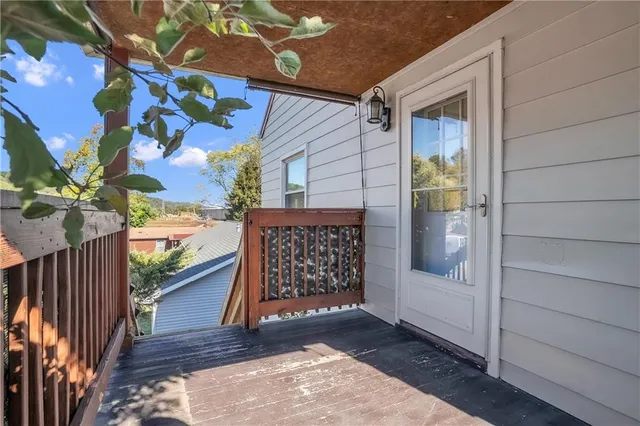 a view of a porch with wooden floor