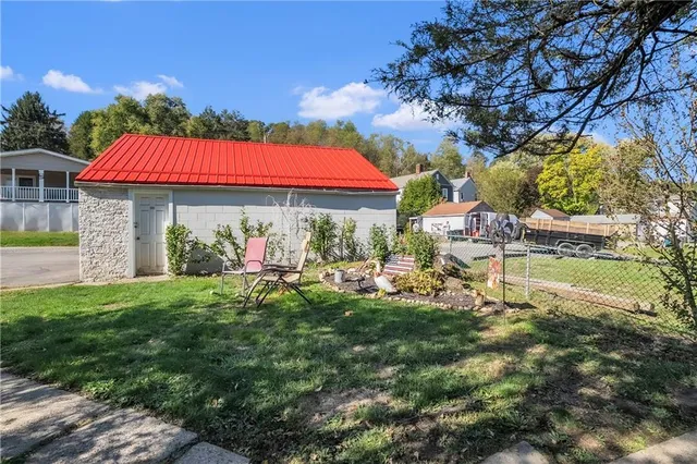 a backyard of a house with outdoor seating