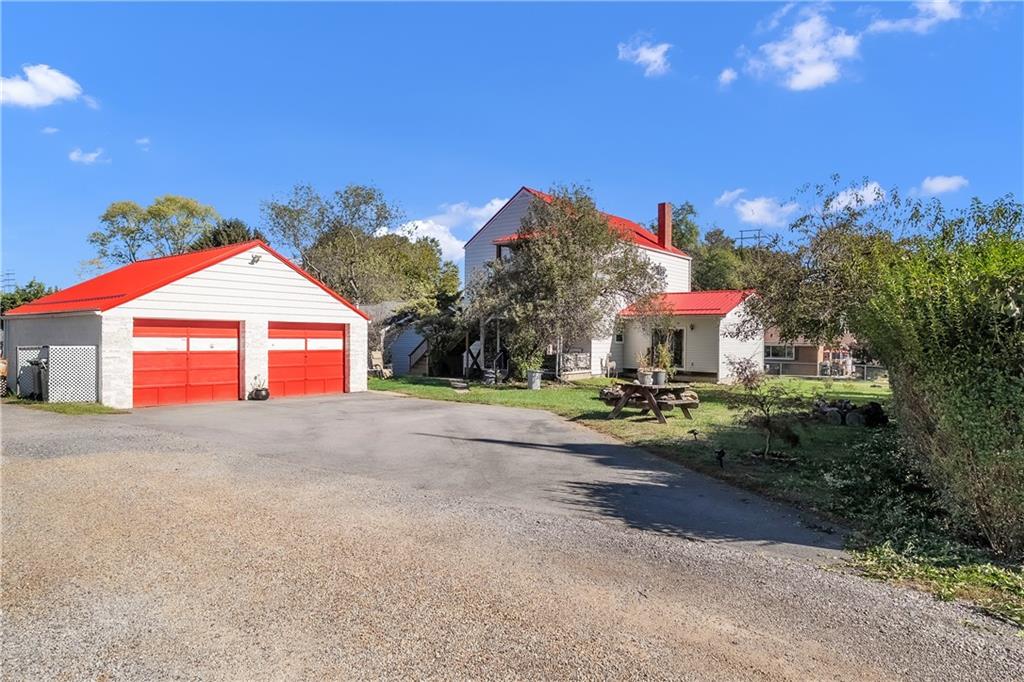 1229 McKee Road Crescent, PA 15046 - Photo 29 of 32 a view of a house with a yard and garage