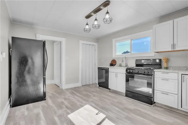 a kitchen with a stove a sink and a refrigerator