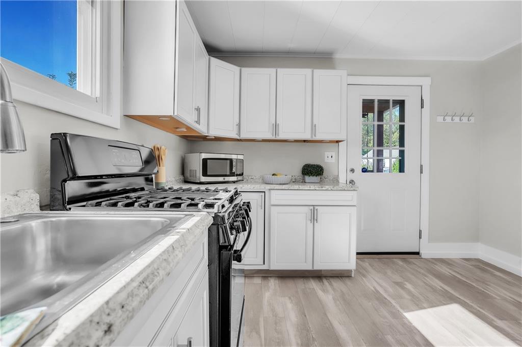 1229 McKee Road Crescent, PA 15046 - Photo 4 of 32 a kitchen with a stove a sink and a refrigerator