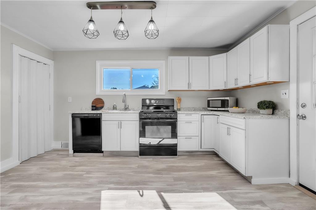 1229 McKee Road Crescent, PA 15046 - Photo 5 of 32 a kitchen with white cabinets and stainless steel appliances