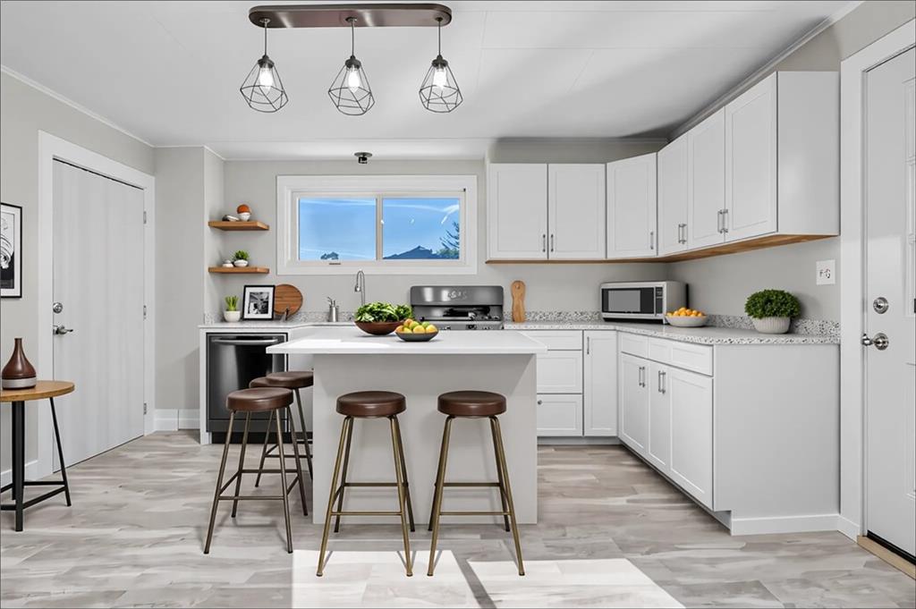 1229 McKee Road Crescent, PA 15046 - Photo 6 of 32 a kitchen with stainless steel appliances granite countertop a refrigerator a stove a sink and white cabinets with wooden floor