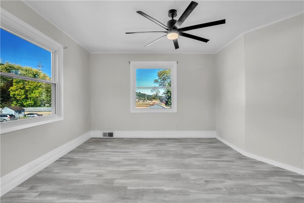 1229 McKee Road Crescent, PA 15046 - Photo 10 of 32 an empty room with wooden floor ceiling fan and windows