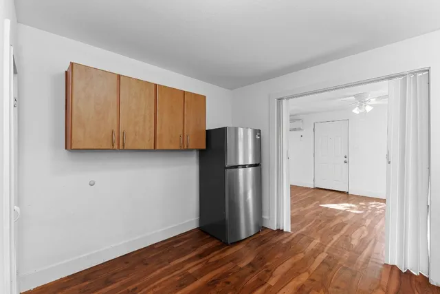 a view of a kitchen with wooden floor