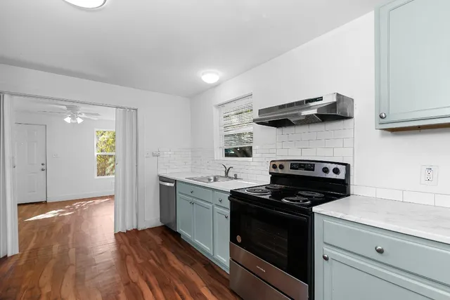 a kitchen with granite countertop stainless steel appliances and wooden cabinets