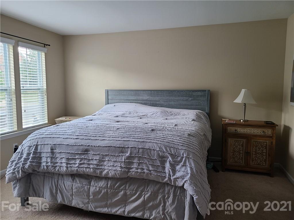 7160 Meyer Road Fort Mill, SC 29715 - Photo 8 of 10 a bed sitting in a bedroom next to a window