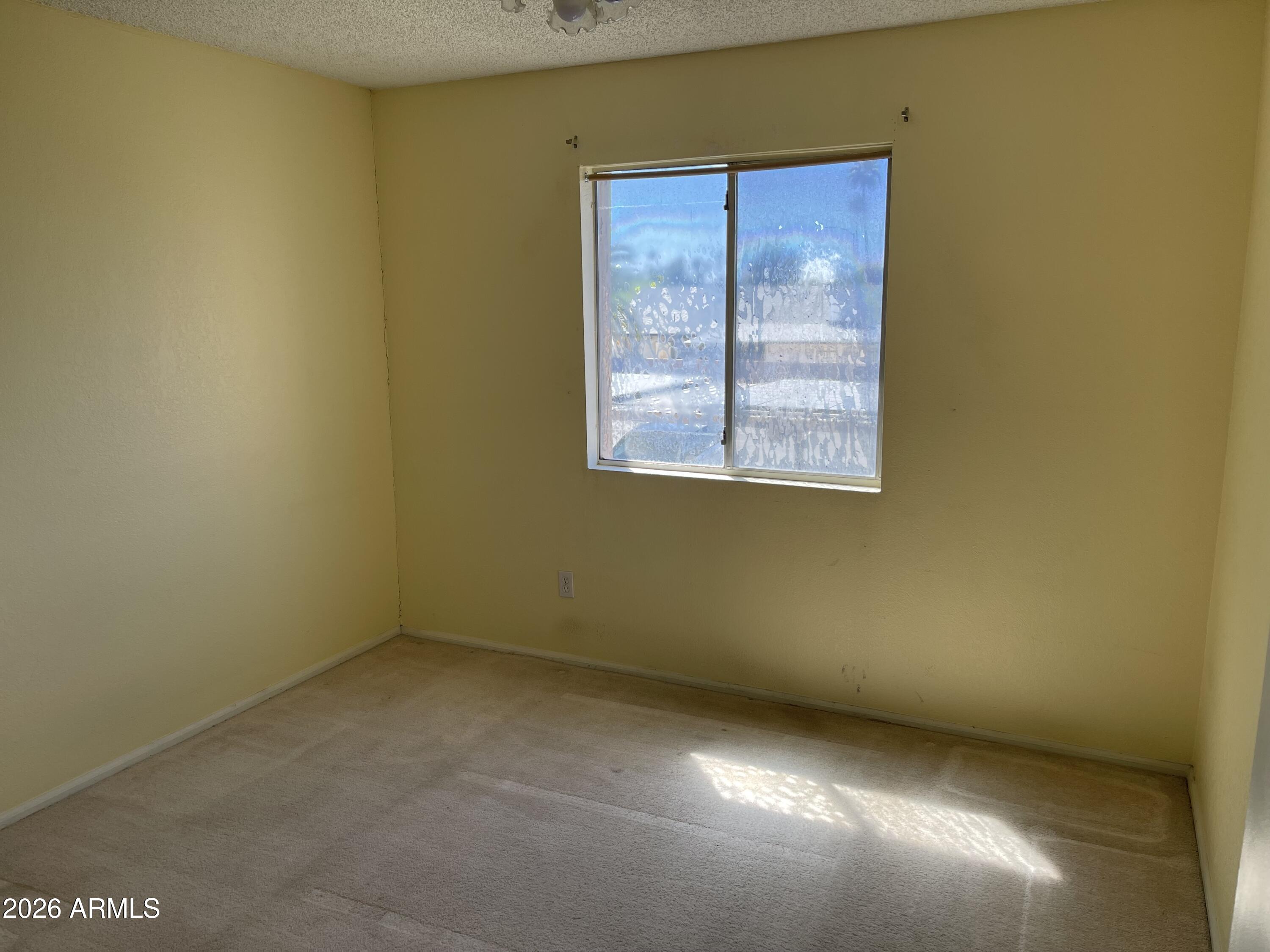 623 West Guadalupe Road, Unit 257 Mesa, AZ 85210 - Photo 11 of 14 an empty room with windows