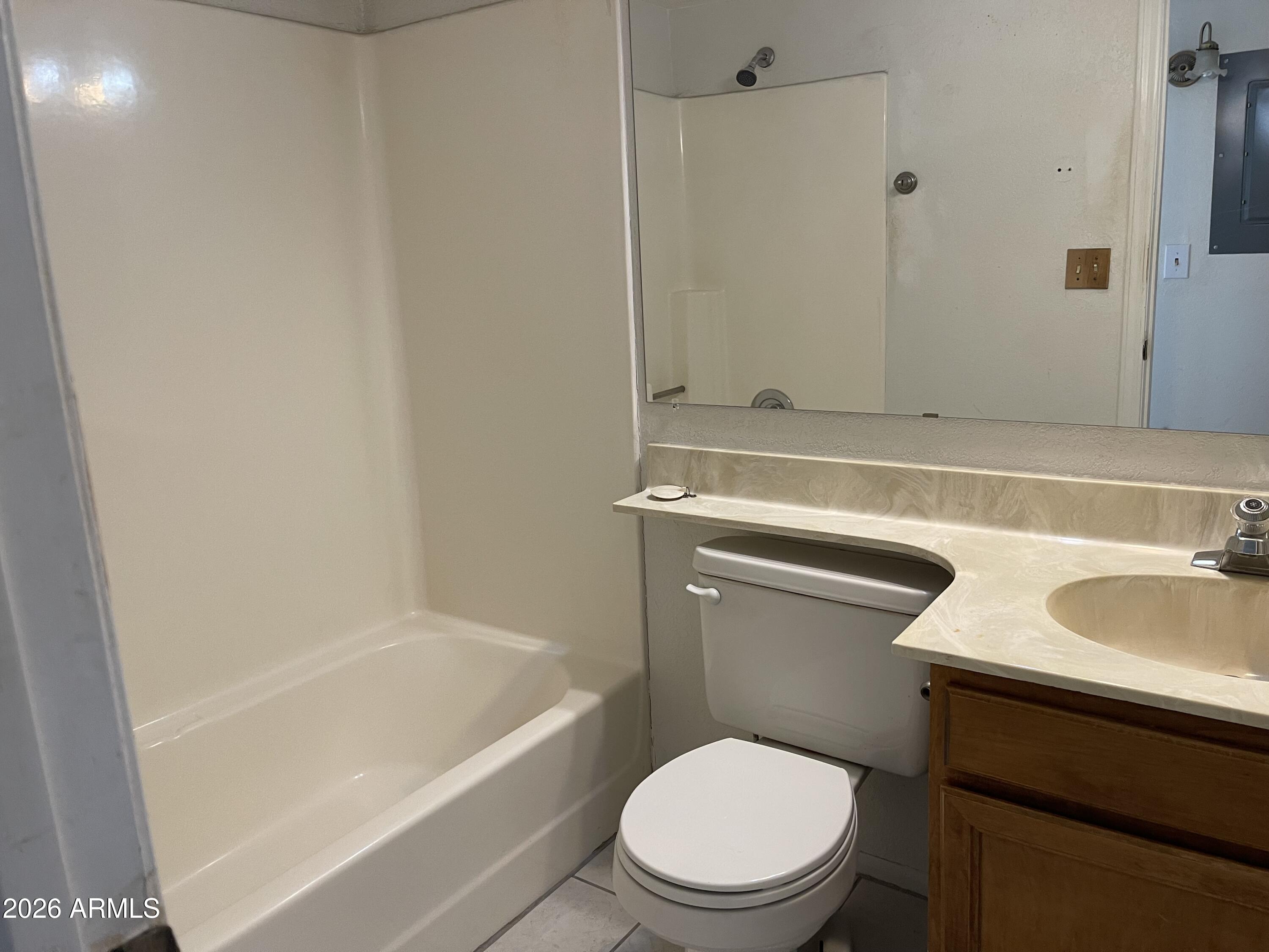 623 West Guadalupe Road, Unit 257 Mesa, AZ 85210 - Photo 6 of 14 a bathroom with a granite countertop toilet a sink and bathtub
