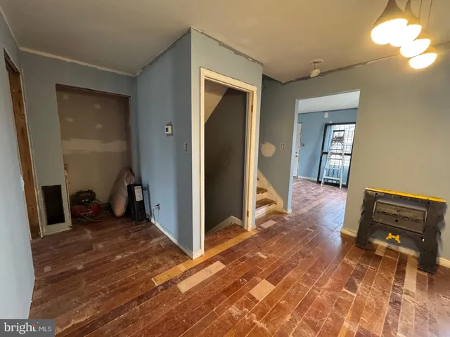 a view of a livingroom with wooden floor and a ceiling fan