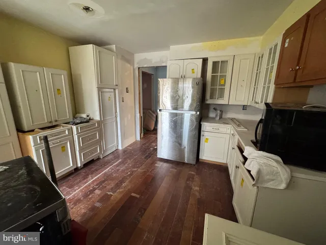 a kitchen with stainless steel appliances a refrigerator sink and wooden cabinets