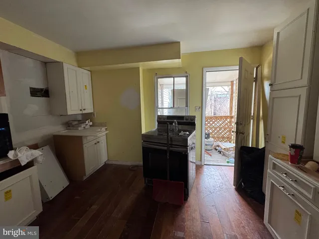 a kitchen with a sink and a stove top oven