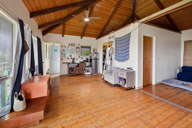 a view of a livingroom with furniture and a flat screen tv