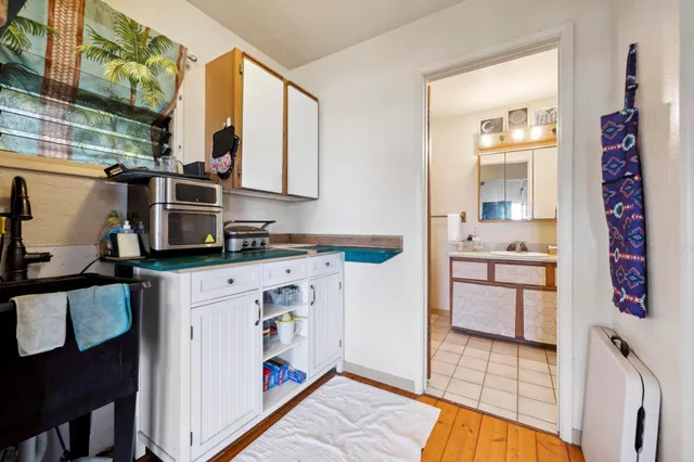 a view of kitchen with stainless steel appliances granite countertop a refrigerator and a stove top oven