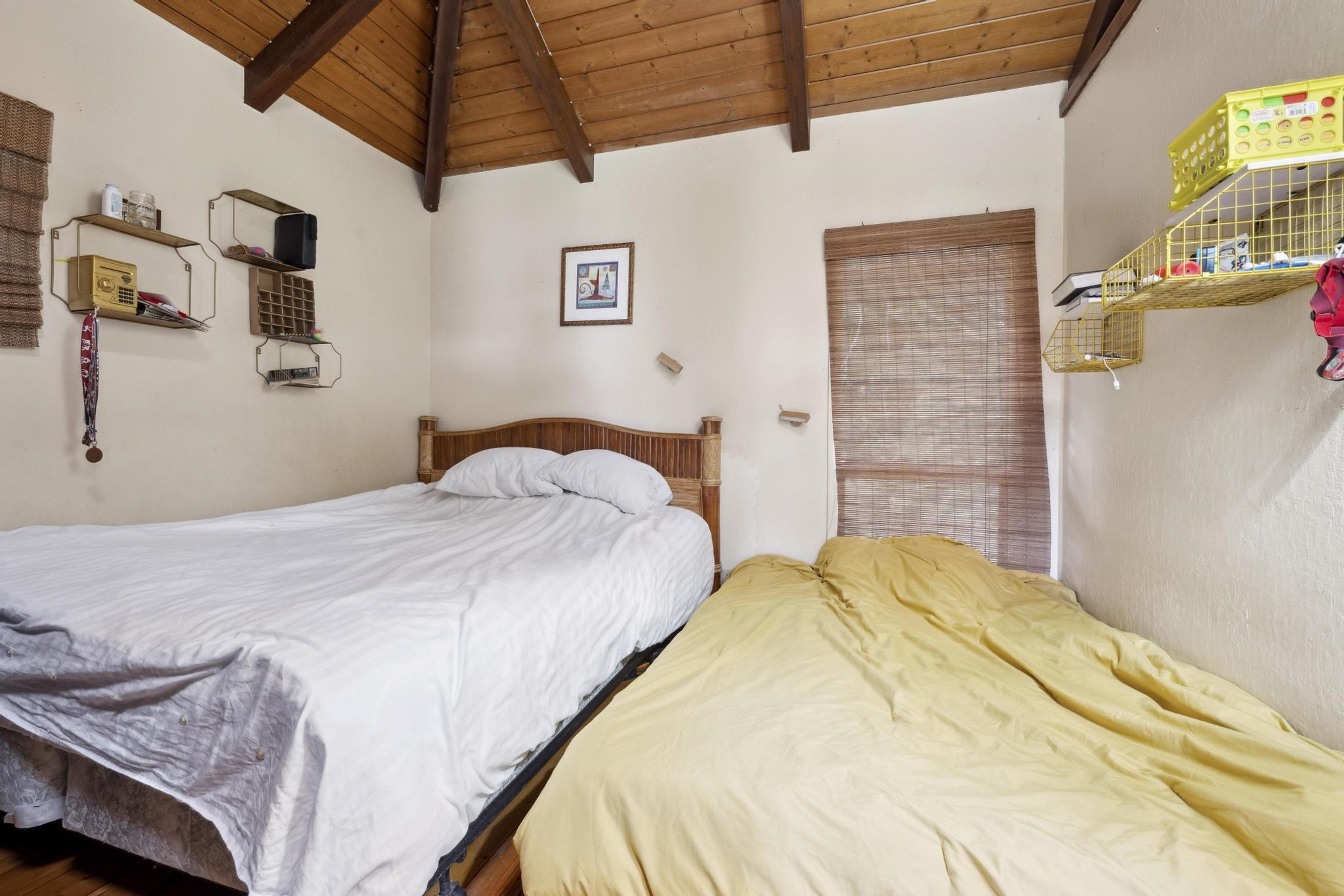 4950 Uakea Road Hana, HI 96713 - Photo 31 of 39 a bedroom with a bed and a table