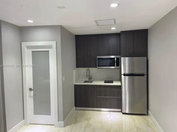 a kitchen with stainless steel appliances a refrigerator and a sink