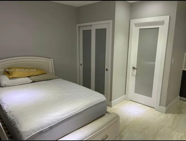 a bedroom with a bed and a mirror