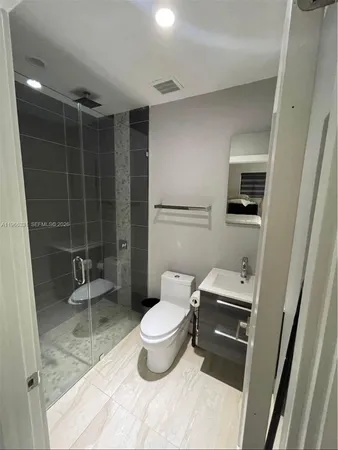 a bathroom with a toilet and a shower
