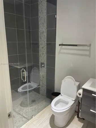 a bathroom with a toilet and a shower
