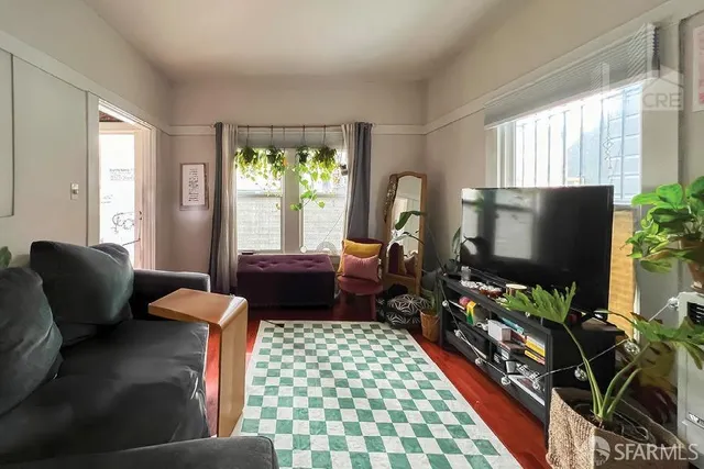 a living room with furniture and a flat screen tv