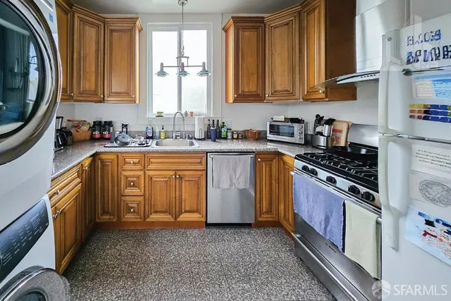 a kitchen with stainless steel appliances granite countertop a stove a sink and a microwave