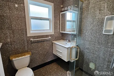 a bathroom with a toilet sink and mirror