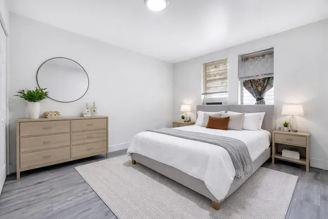 a bedroom with a bed and a dresser